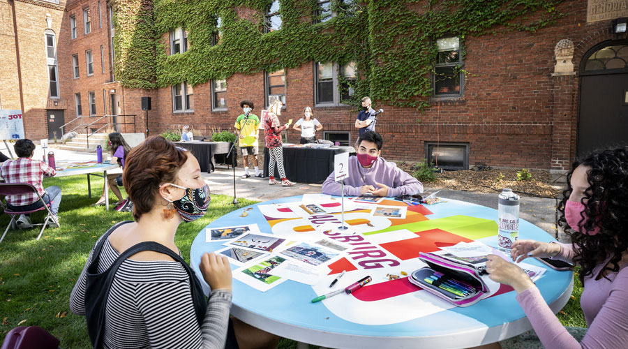 Students in the quad working at a round table